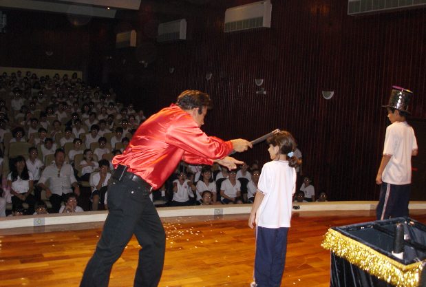 M�gico Torrine e dois alunos participando da apresenta��o